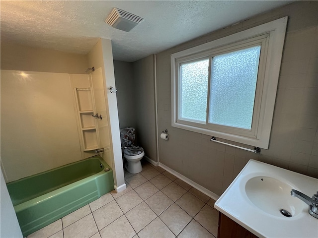 full bathroom with a textured ceiling, toilet, tile patterned flooring, and vanity