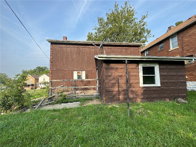 rear view of house with a yard