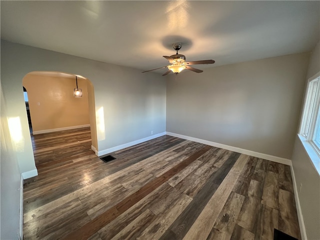 spare room with ceiling fan and dark hardwood / wood-style flooring