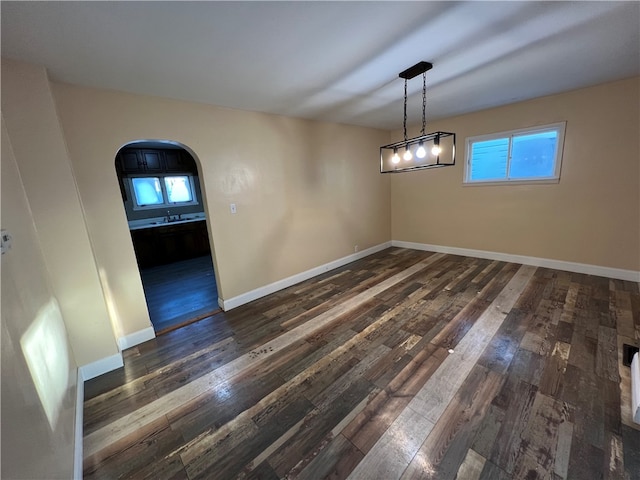 empty room with dark hardwood / wood-style flooring