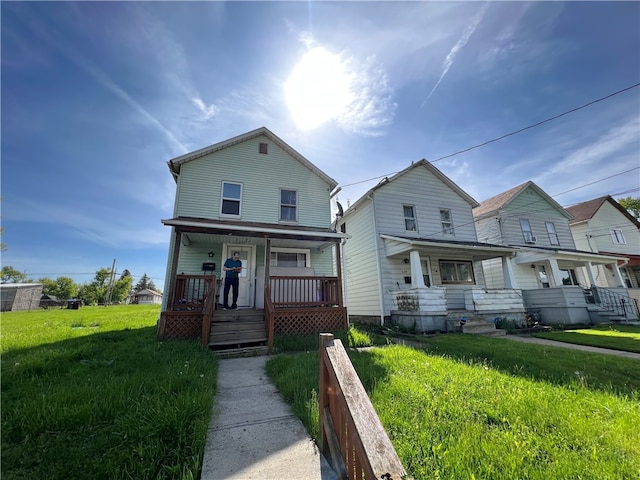 view of front of home featuring a front yard and covered porch