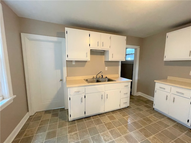 kitchen featuring sink and white cabinetry