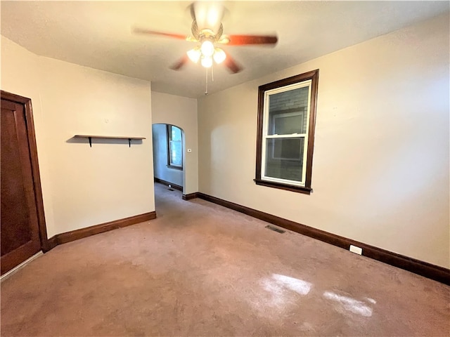 unfurnished room with ceiling fan