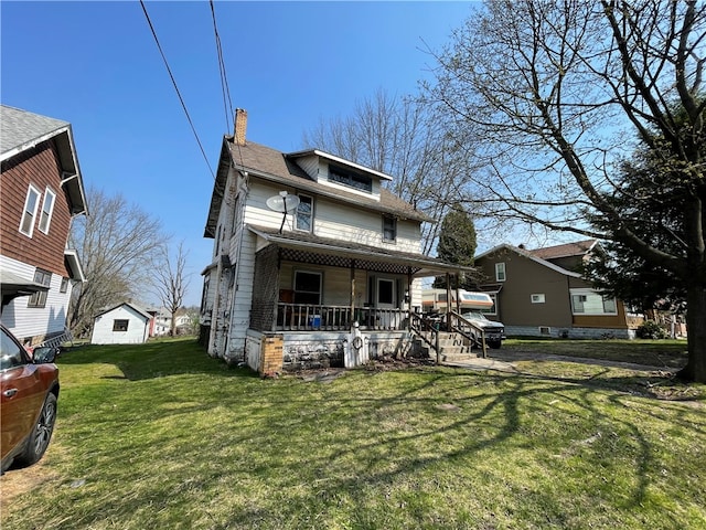 rear view of property with a lawn