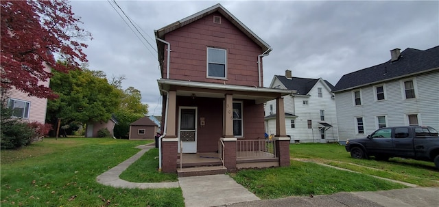 view of front of property featuring covered porch and a front lawn