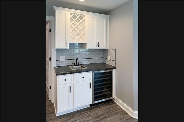 bar with dark wood-type flooring, white cabinets, sink, wine cooler, and decorative backsplash