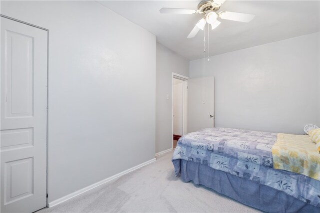 bedroom with ceiling fan and light colored carpet