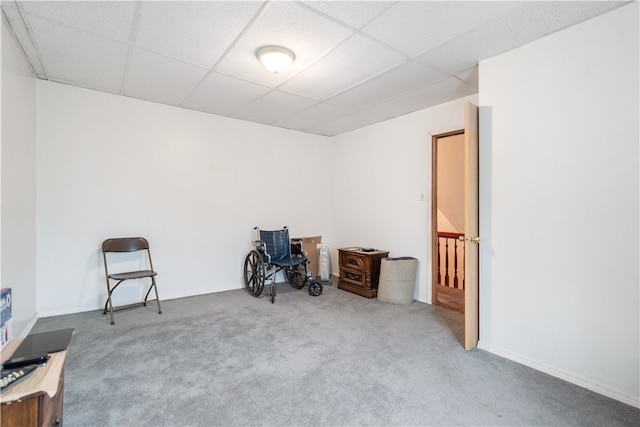 miscellaneous room featuring a paneled ceiling and light colored carpet