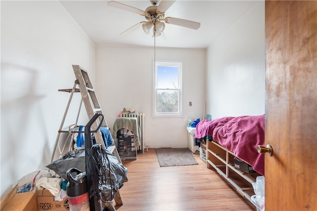 bedroom featuring light hardwood / wood-style floors and ceiling fan