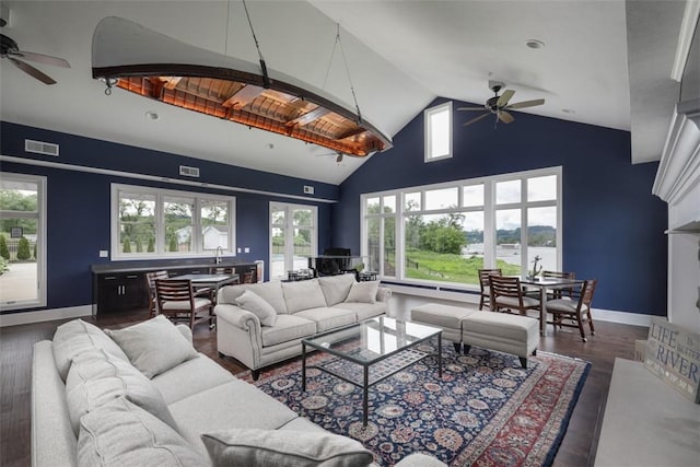 living room featuring ceiling fan, dark hardwood / wood-style flooring, and high vaulted ceiling