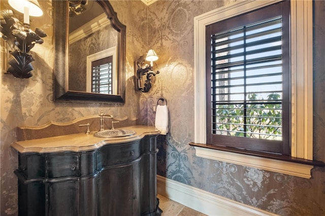 bathroom with ornamental molding and vanity