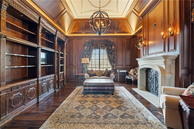 living area with wood walls, coffered ceiling, built in shelves, and dark hardwood / wood-style floors