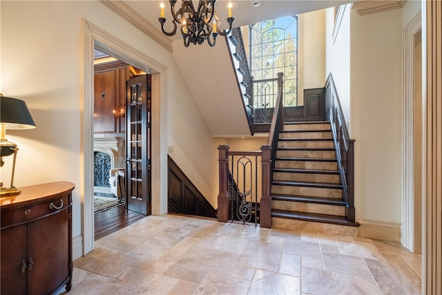 entryway featuring a chandelier, crown molding, and light hardwood / wood-style floors