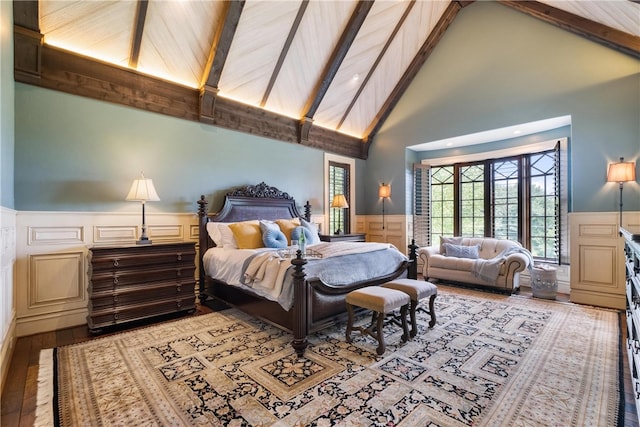 bedroom with beam ceiling, wooden ceiling, light hardwood / wood-style floors, and high vaulted ceiling