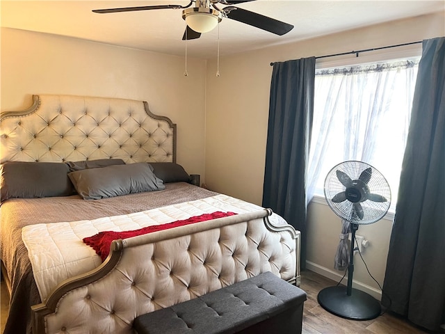 bedroom with ceiling fan and hardwood / wood-style floors