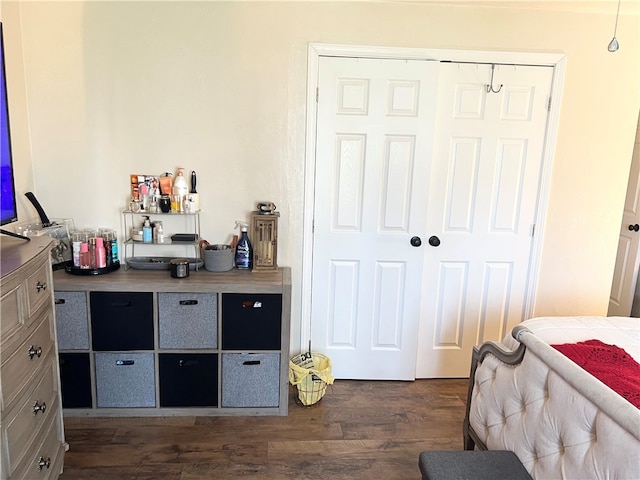 bedroom featuring a closet and dark hardwood / wood-style flooring