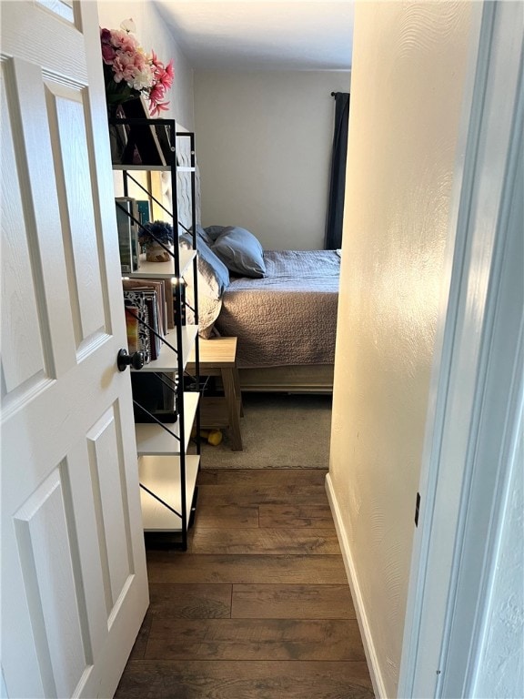 bedroom with dark hardwood / wood-style floors