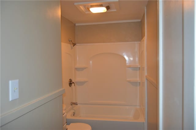 bathroom featuring toilet and bathing tub / shower combination