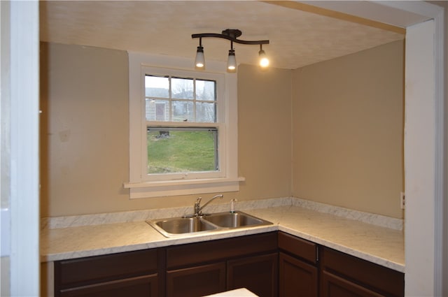 kitchen with dark brown cabinetry and sink