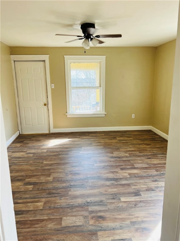 unfurnished room featuring ceiling fan and dark hardwood / wood-style floors