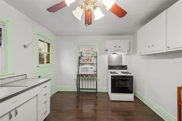 kitchen featuring ceiling fan, white appliances, dark wood-type flooring, and white cabinetry