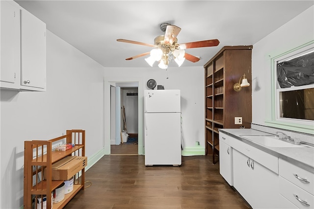 kitchen featuring white fridge, ceiling fan, white cabinetry, dark hardwood / wood-style floors, and sink