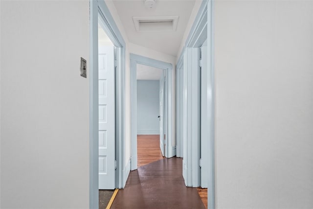 corridor with dark hardwood / wood-style flooring