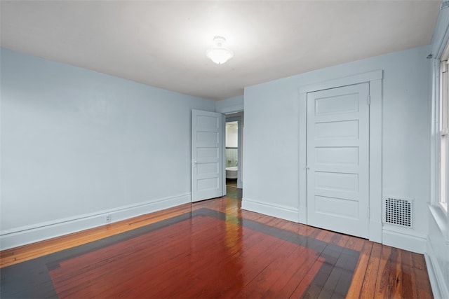 empty room featuring dark wood-type flooring