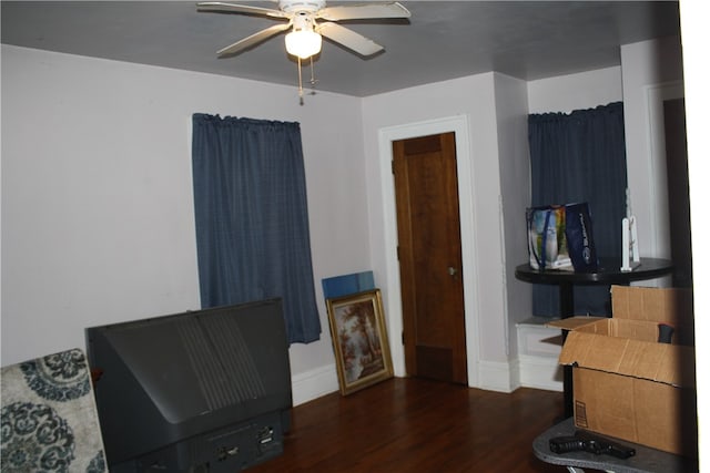 miscellaneous room featuring ceiling fan and dark wood-type flooring