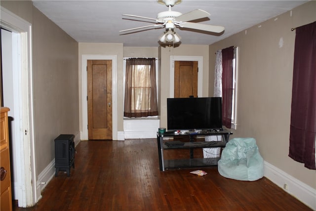 living room featuring dark hardwood / wood-style flooring and ceiling fan