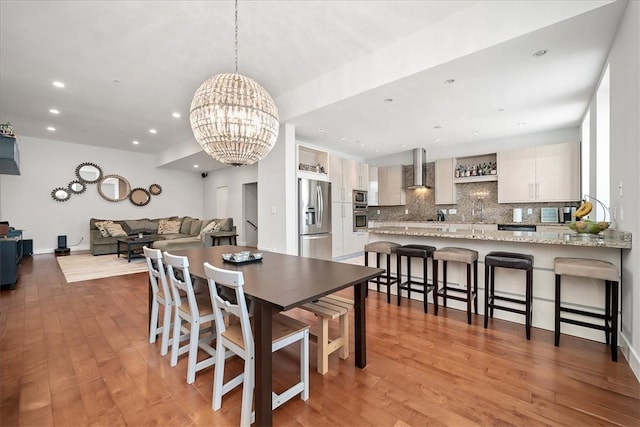 dining room with an inviting chandelier and light wood-type flooring