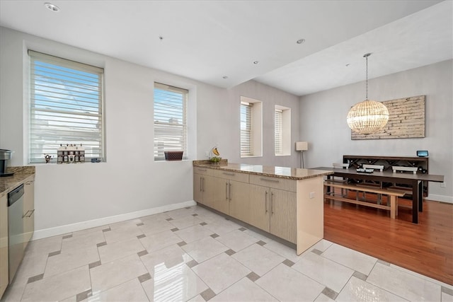 kitchen with a chandelier, hanging light fixtures, stone countertops, and light tile floors