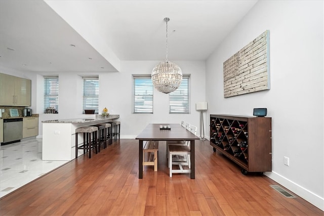 dining room with an inviting chandelier and hardwood / wood-style floors