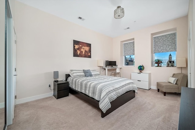 bedroom featuring light colored carpet