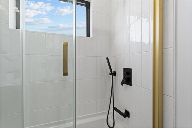 bathroom with a tile shower