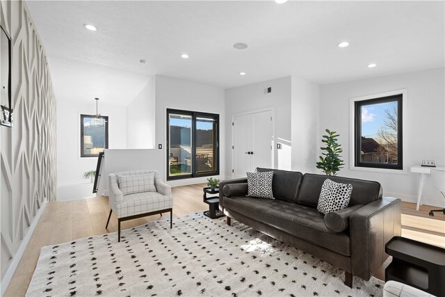 living room featuring a chandelier and light hardwood / wood-style floors