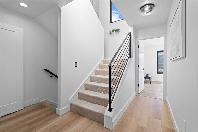 staircase with light hardwood / wood-style floors