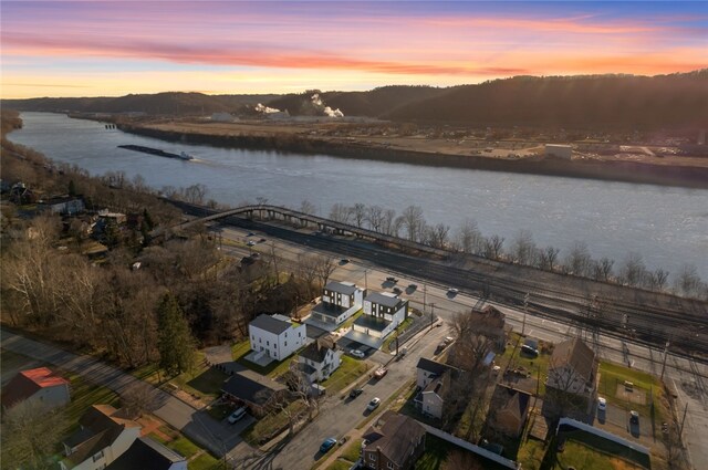 aerial view at dusk with a water view