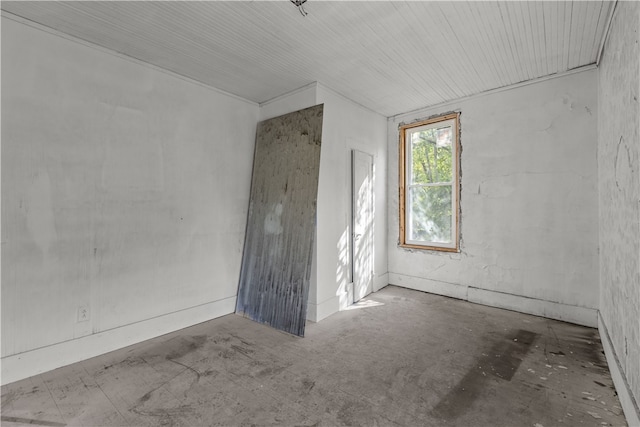 unfurnished room with concrete flooring