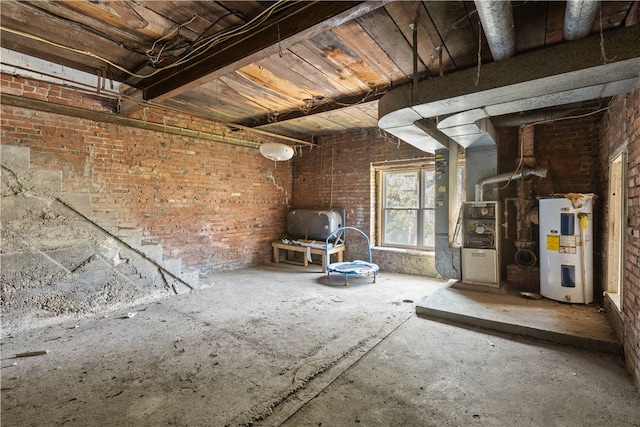 interior space with brick wall, heating unit, and water heater