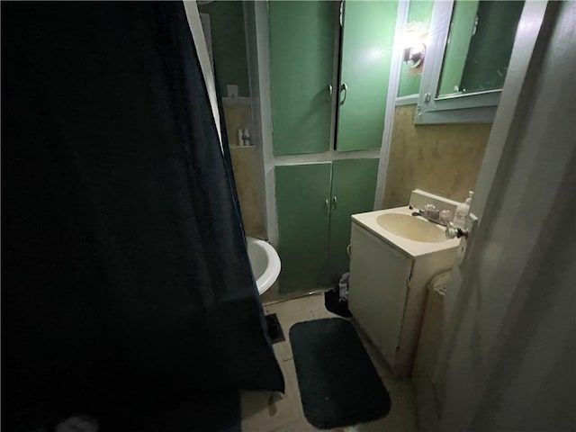 bathroom featuring vanity, toilet, and tile patterned flooring