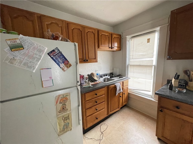 kitchen with sink and white fridge