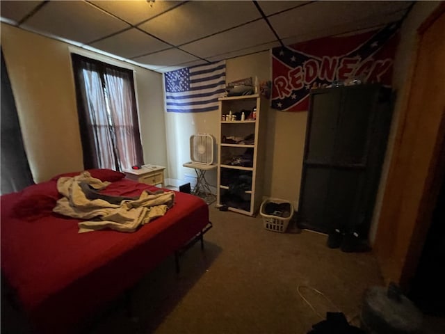 bedroom featuring a paneled ceiling and carpet floors