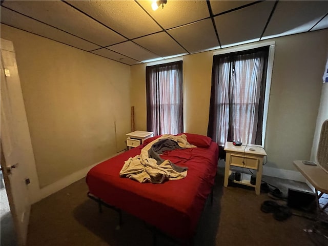 bedroom with carpet and a drop ceiling