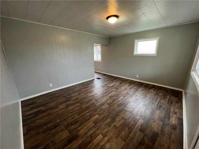 spare room with dark hardwood / wood-style flooring