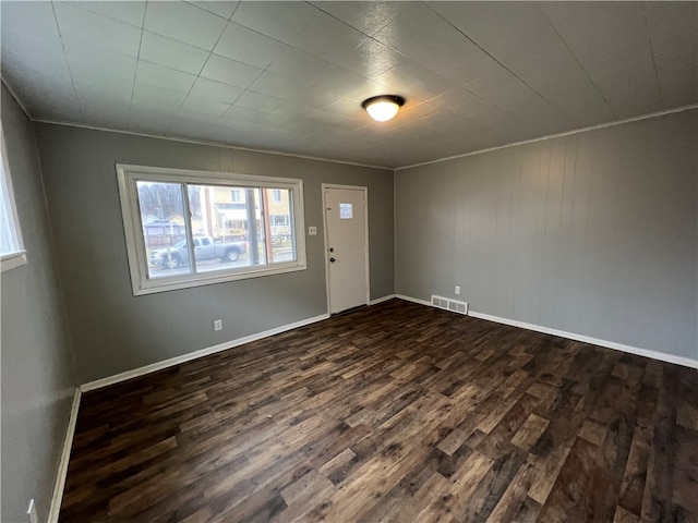 foyer entrance with crown molding and dark hardwood / wood-style flooring