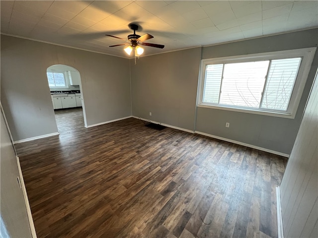 spare room with ornamental molding, dark hardwood / wood-style floors, and ceiling fan