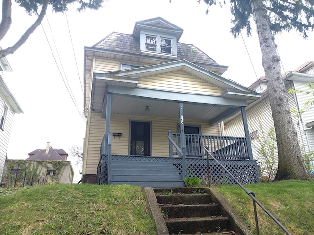 bungalow-style house with a front lawn and a porch