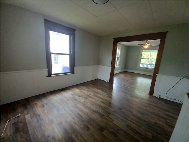 empty room featuring dark hardwood / wood-style floors and ceiling fan