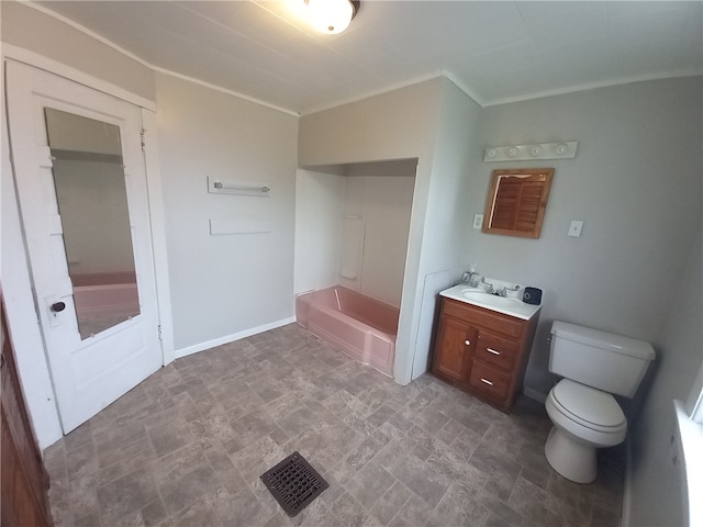 bathroom featuring vanity, toilet, and a tub to relax in